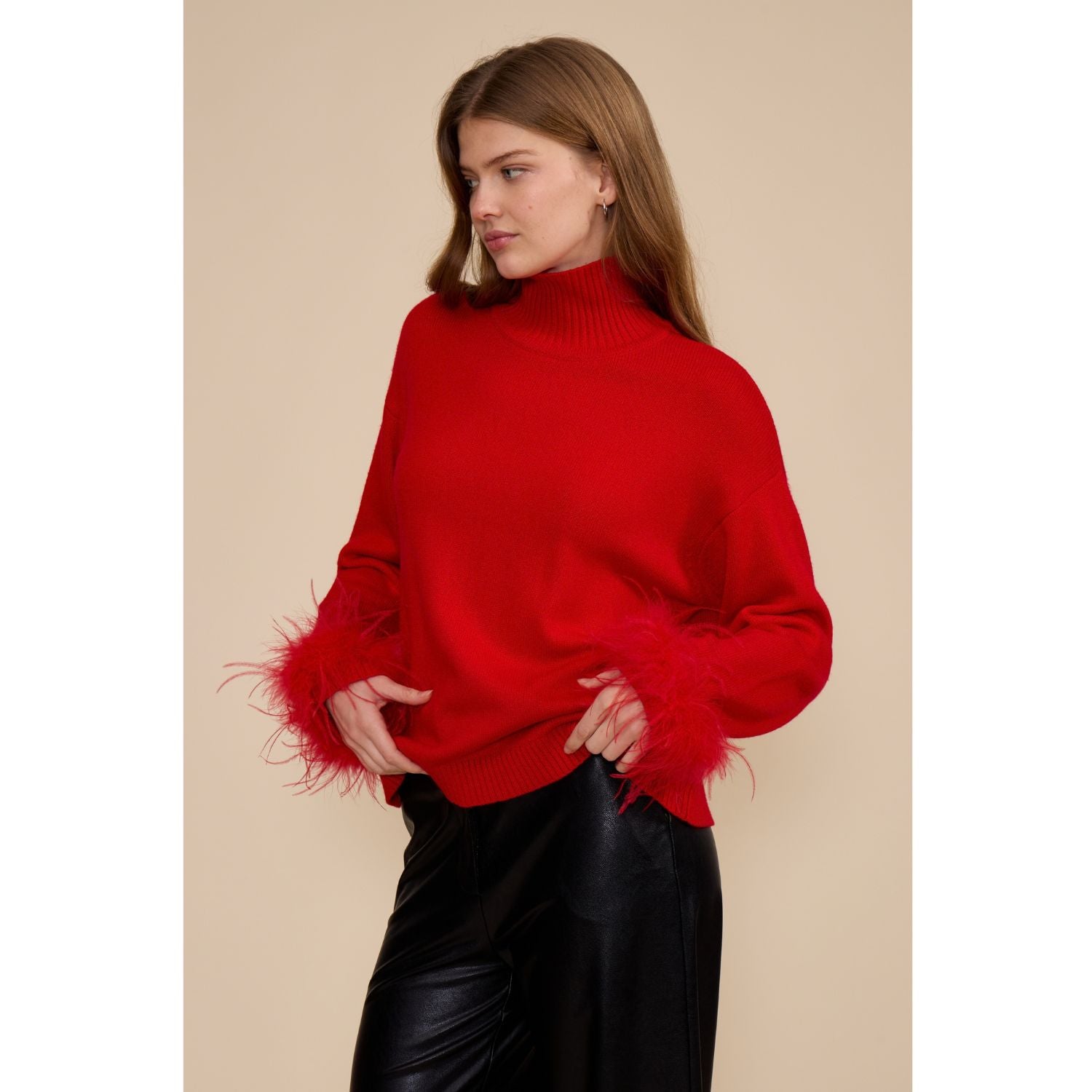 Red Clark Feather Trim Sweater with a ribbed mock neck, relaxed fit, dropped shoulders, and feather-trimmed cuffs