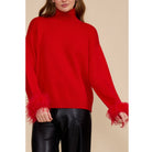 Red Clark Feather Trim Sweater with a ribbed mock neck, relaxed fit, dropped shoulders, and feather-trimmed cuffs