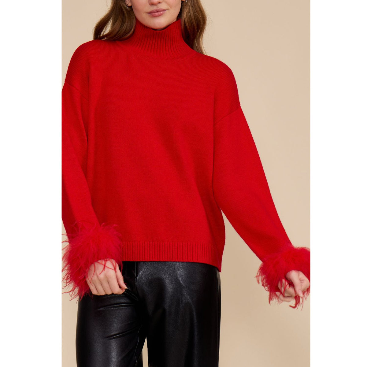 Red Clark Feather Trim Sweater with a ribbed mock neck, relaxed fit, dropped shoulders, and feather-trimmed cuffs