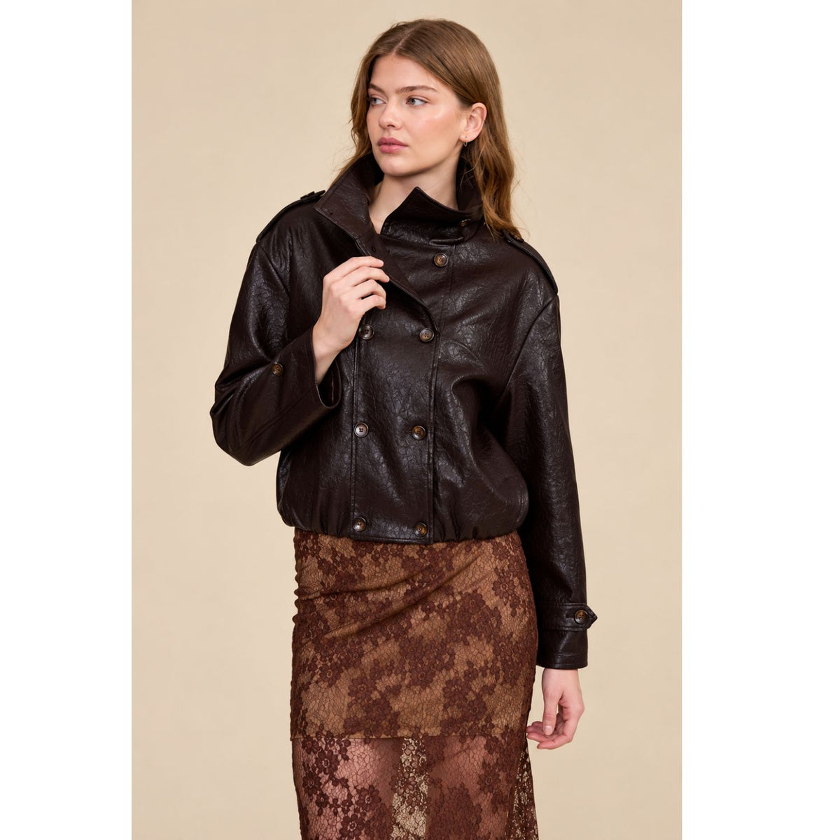 A relaxed chocolate brown jacket featuring a double-breasted front, oversized collar, gathered hem, and button-tab cuffs for a polished everyday look