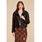 A relaxed chocolate brown jacket featuring a double-breasted front, oversized collar, gathered hem, and button-tab cuffs for a polished everyday look