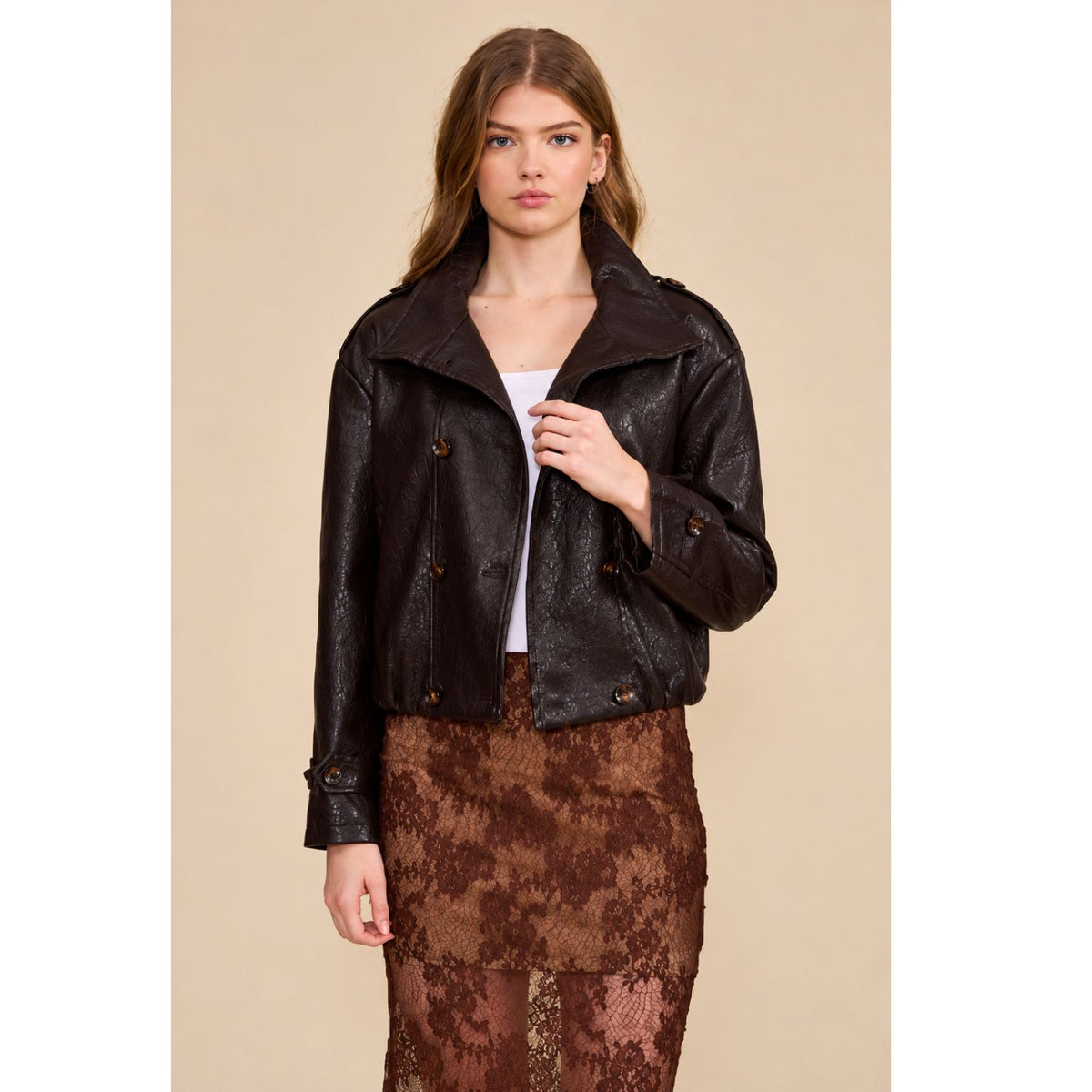 A relaxed chocolate brown jacket featuring a double-breasted front, oversized collar, gathered hem, and button-tab cuffs for a polished everyday look