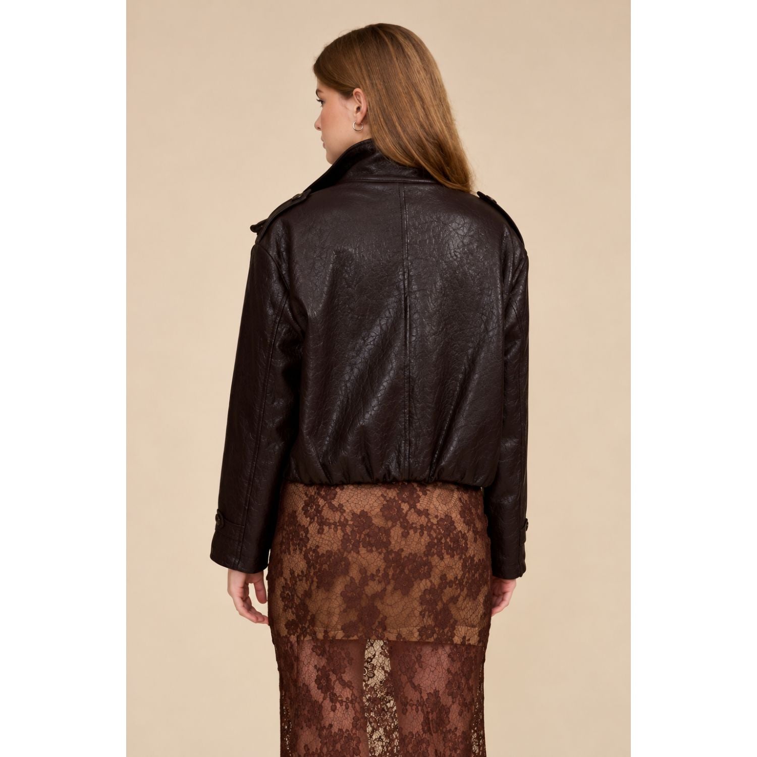 A relaxed chocolate brown jacket featuring a double-breasted front, oversized collar, gathered hem, and button-tab cuffs for a polished everyday look