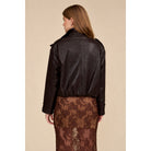 A relaxed chocolate brown jacket featuring a double-breasted front, oversized collar, gathered hem, and button-tab cuffs for a polished everyday look