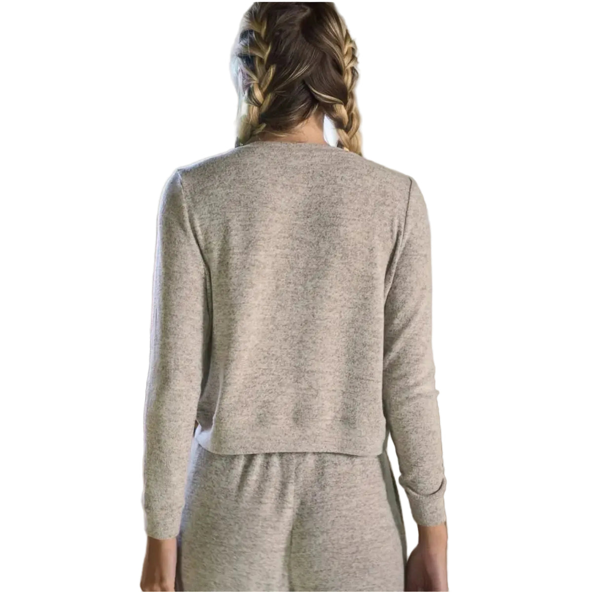 A woman viewed from behind wearing a light heather gray knit long-sleeve top and matching bottoms in a bright indoor room.