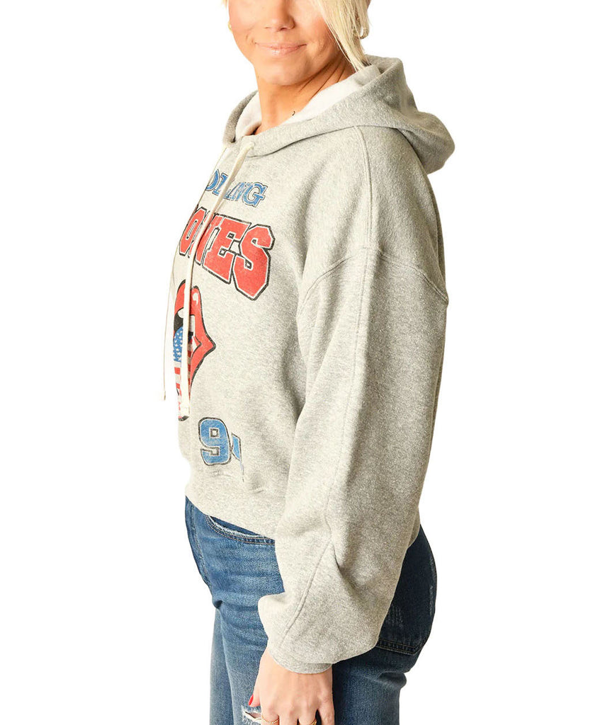 Rolling Stones Hoodie Heather Grey. Embrace the spirit of rock history with The Rolling Stones USA 1994 Hoodie. This hoodie provides cozy comfort while making a sustainable statement. It's a classic yet forward-thinking addition to any collection, offering warmth for the cool moments and a salute to timeless tunes.