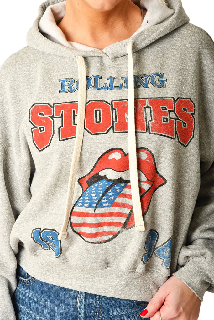 Rolling Stones Hoodie Heather Grey. Embrace the spirit of rock history with The Rolling Stones USA 1994 Hoodie. This hoodie provides cozy comfort while making a sustainable statement. It's a classic yet forward-thinking addition to any collection, offering warmth for the cool moments and a salute to timeless tunes.