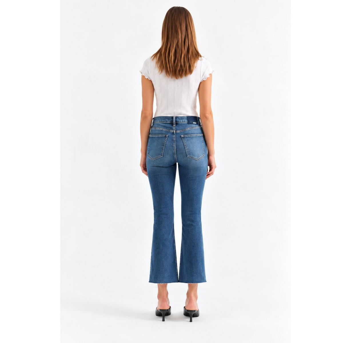 Shy Girl in Influencer Jeans featuring a deep blue wash, high-rise cropped flare silhouette, and scissor-cut hem