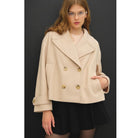 Women's neutral double-breasted cropped peacoat with wide notched lapels, button-tab cuffs, and a relaxed boxy fit
