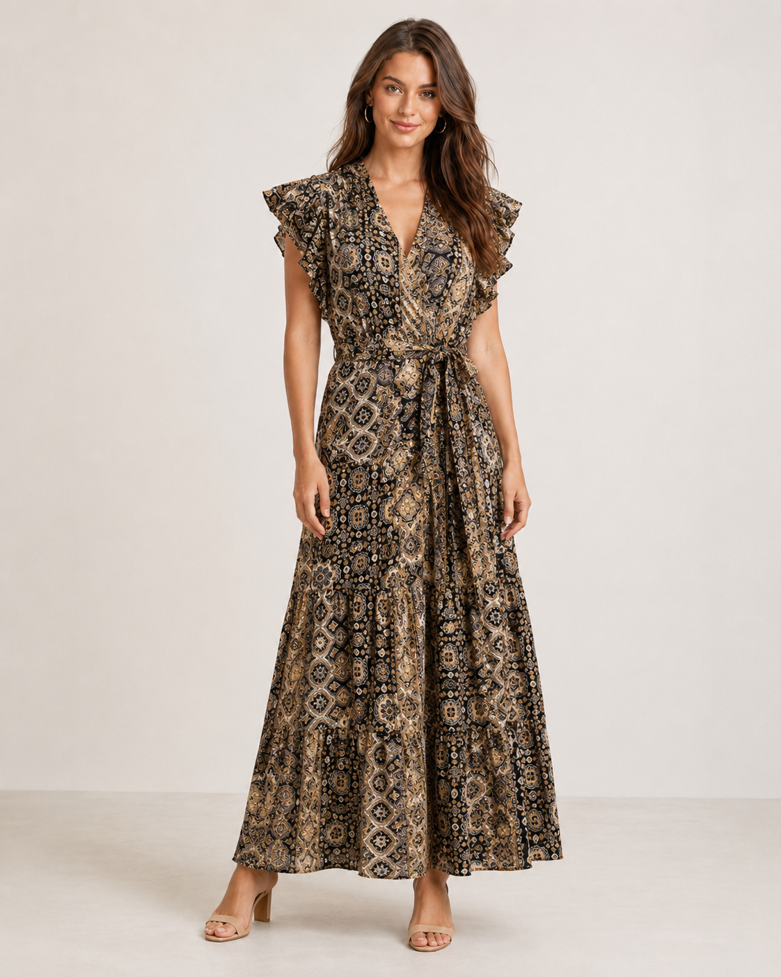 woman wearing a blue printed sleeveless wrap maxi dress with ruffle trim on the sleeves and a tie waist