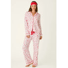 Ivory three-piece holiday pajama set with red Christmas print, button-front top, pants, and matching eye mask