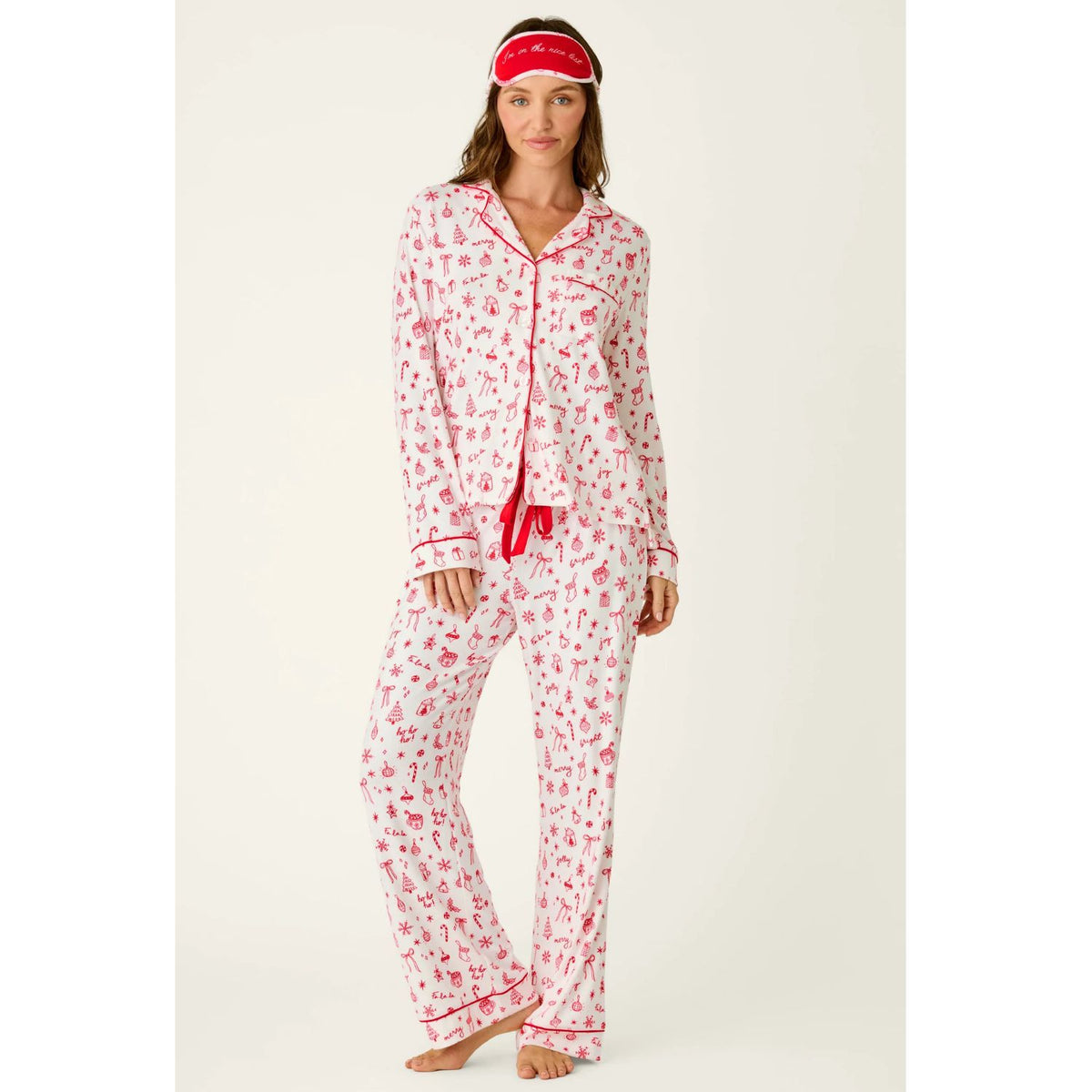 Ivory three-piece holiday pajama set with red Christmas print, button-front top, pants, and matching eye mask