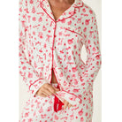 Ivory three-piece holiday pajama set with red Christmas print, button-front top, pants, and matching eye mask