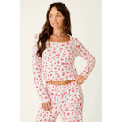 Ivory cropped pajama top with red Christmas print, scoop neckline, and long sleeves