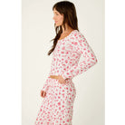 Ivory cropped pajama top with red Christmas print, scoop neckline, and long sleeves