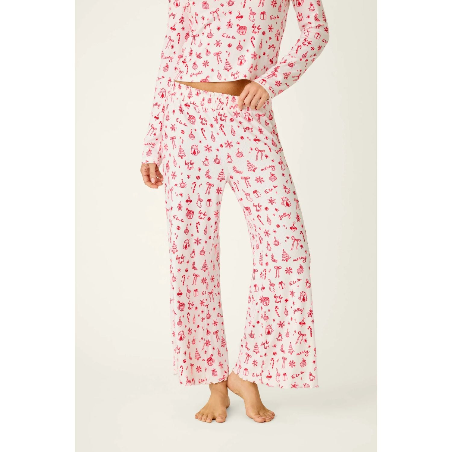 Ivory cropped pajama pants with red holiday print, smocked waistband, and open-leg silhouette