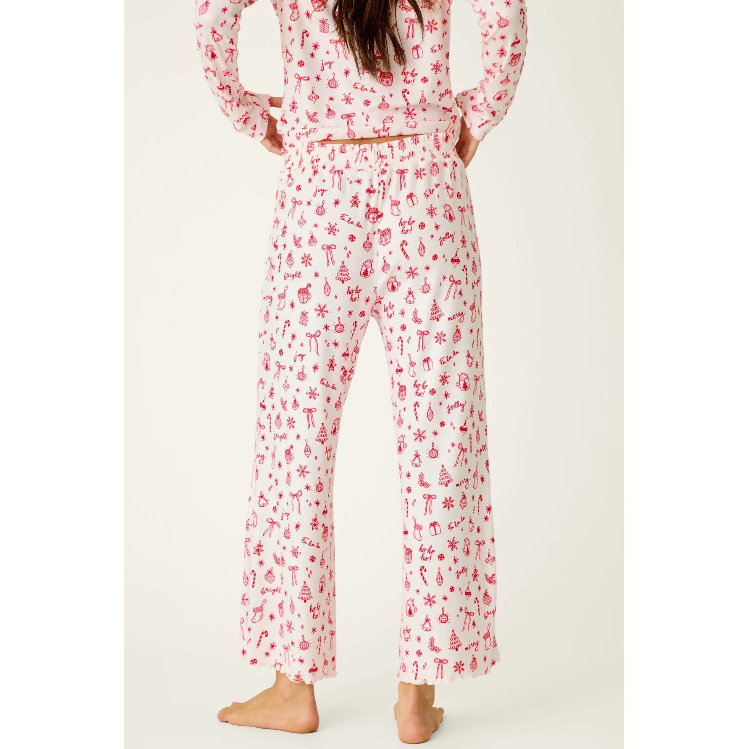 Ivory cropped pajama pants with red holiday print, smocked waistband, and open-leg silhouette