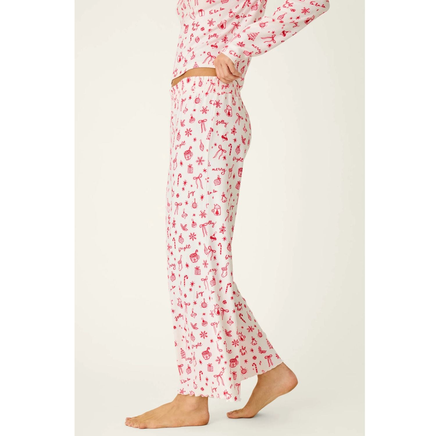 Ivory cropped pajama pants with red holiday print, smocked waistband, and open-leg silhouette