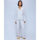 A cozy two-piece sleep set featuring brushed Pillowsoft fabric, a button-front top with contrast piping, and full-length drawstring pants for relaxing in comfort