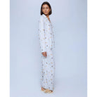 A cozy two-piece sleep set featuring brushed Pillowsoft fabric, a button-front top with contrast piping, and full-length drawstring pants for relaxing in comfort