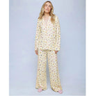 A cozy two-piece sleep set featuring brushed Pillowsoft fabric, a button-front top with contrast piping, and full-length drawstring pants for relaxing in comfort