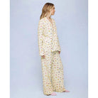 A cozy two-piece sleep set featuring brushed Pillowsoft fabric, a button-front top with contrast piping, and full-length drawstring pants for relaxing in comfort
