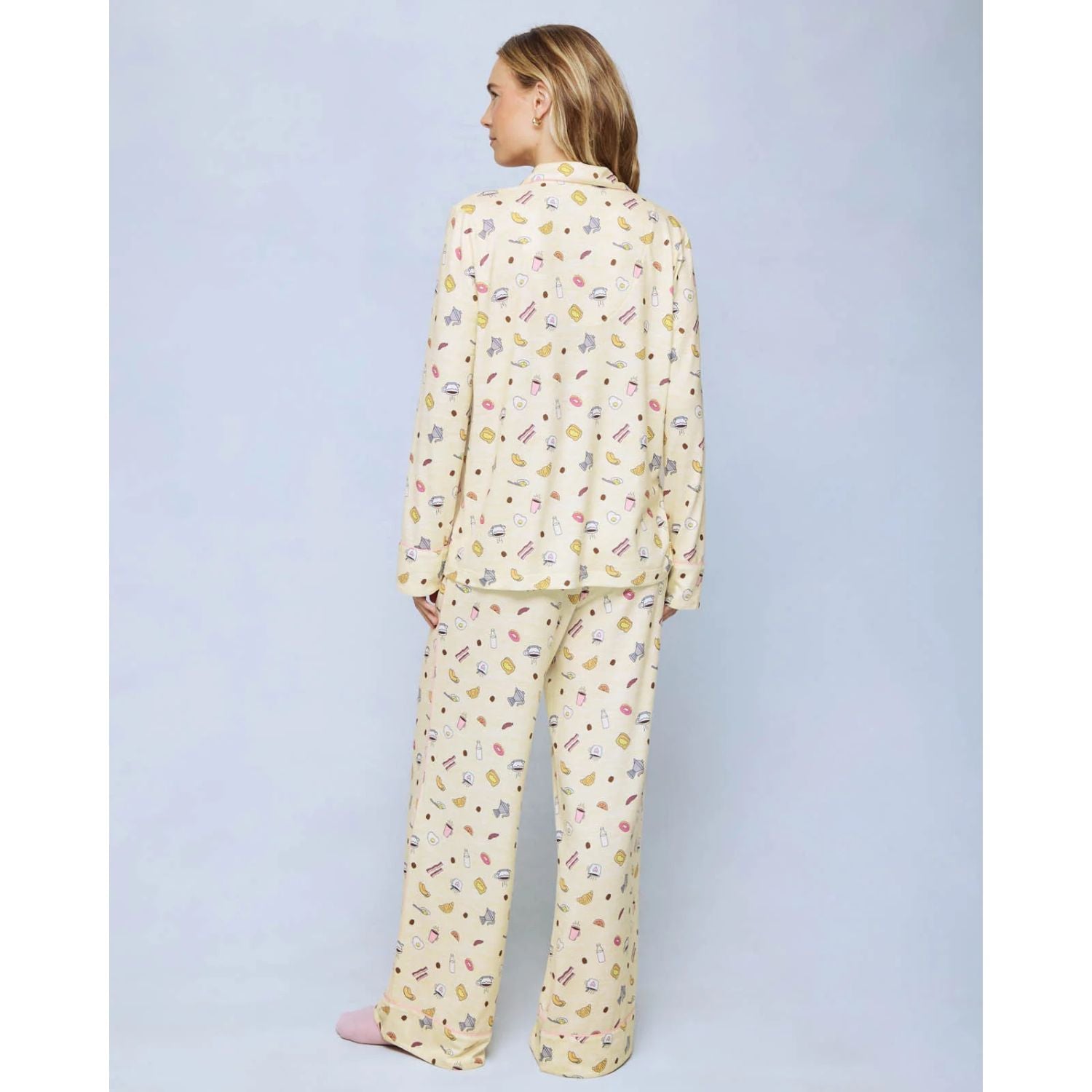 A cozy two-piece sleep set featuring brushed Pillowsoft fabric, a button-front top with contrast piping, and full-length drawstring pants for relaxing in comfort