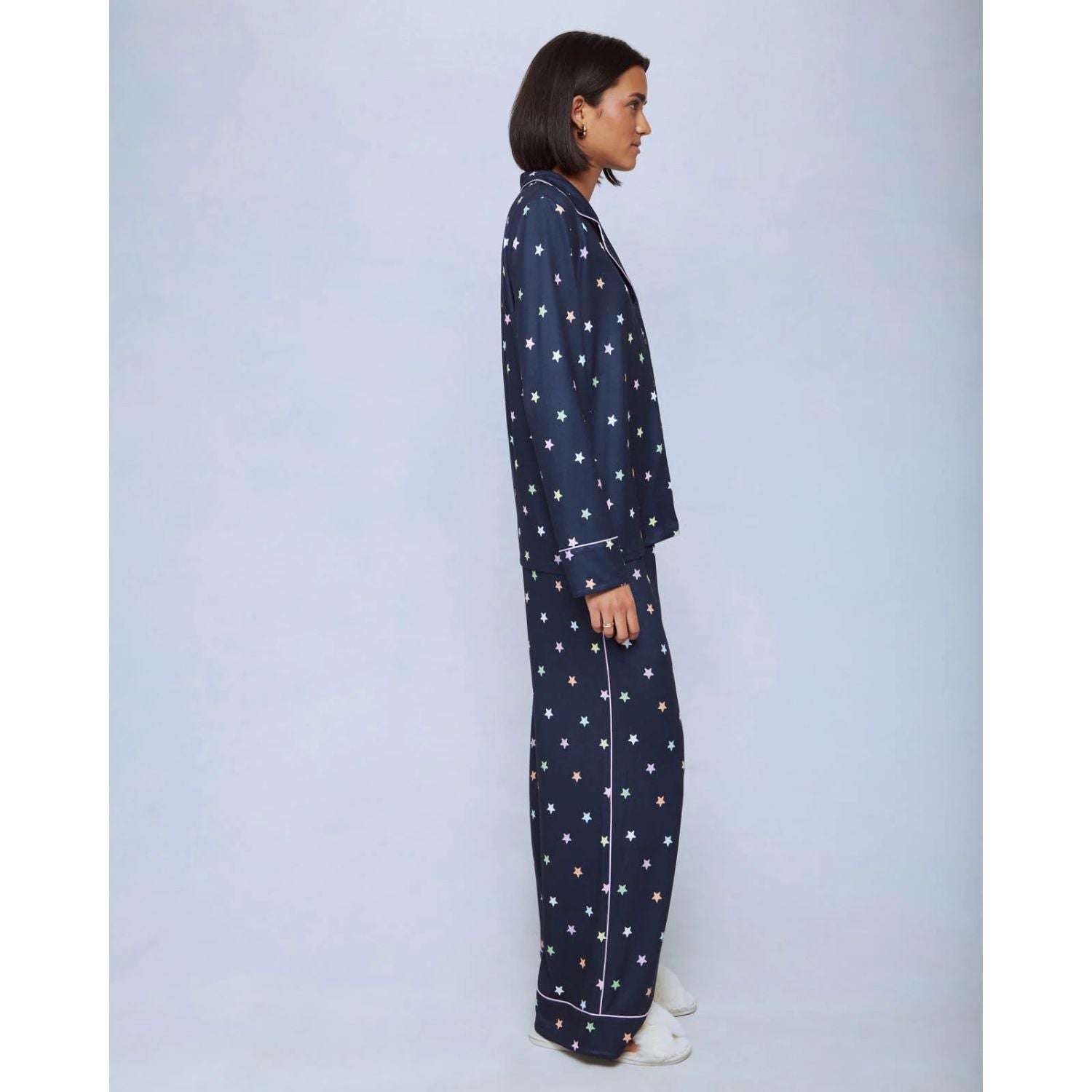A cozy two-piece sleep set featuring brushed Pillowsoft fabric, a button-front top with contrast piping, and full-length drawstring pants for relaxing in comfort
