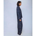 A cozy two-piece sleep set featuring brushed Pillowsoft fabric, a button-front top with contrast piping, and full-length drawstring pants for relaxing in comfort