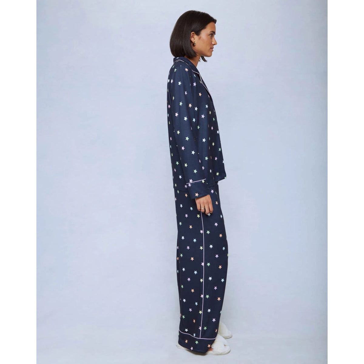 A cozy two-piece sleep set featuring brushed Pillowsoft fabric, a button-front top with contrast piping, and full-length drawstring pants for relaxing in comfort