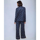 A cozy two-piece sleep set featuring brushed Pillowsoft fabric, a button-front top with contrast piping, and full-length drawstring pants for relaxing in comfort