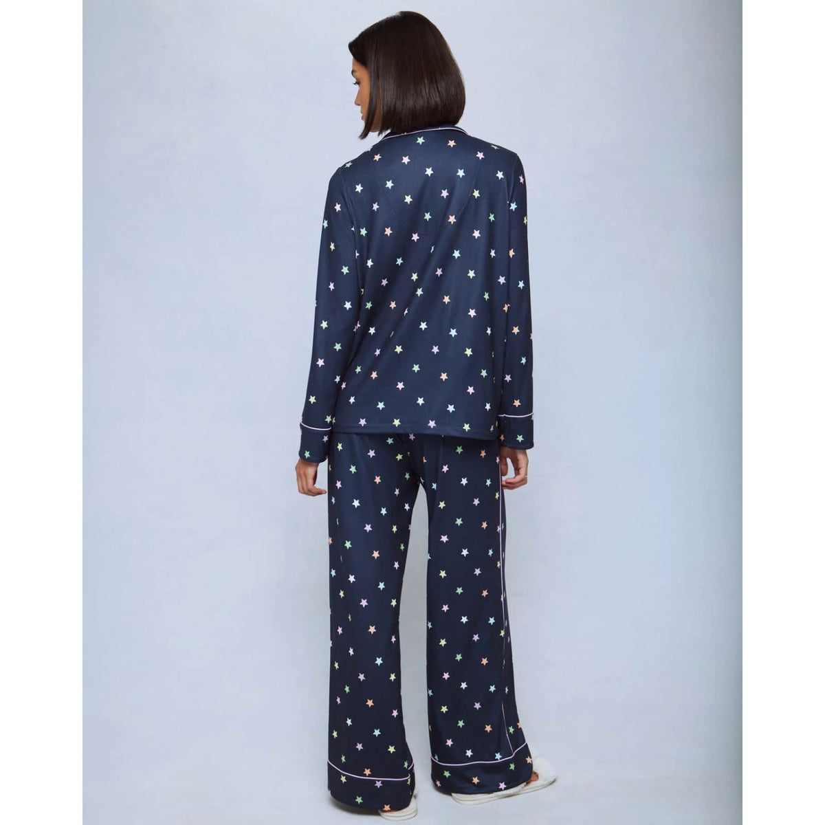 A cozy two-piece sleep set featuring brushed Pillowsoft fabric, a button-front top with contrast piping, and full-length drawstring pants for relaxing in comfort
