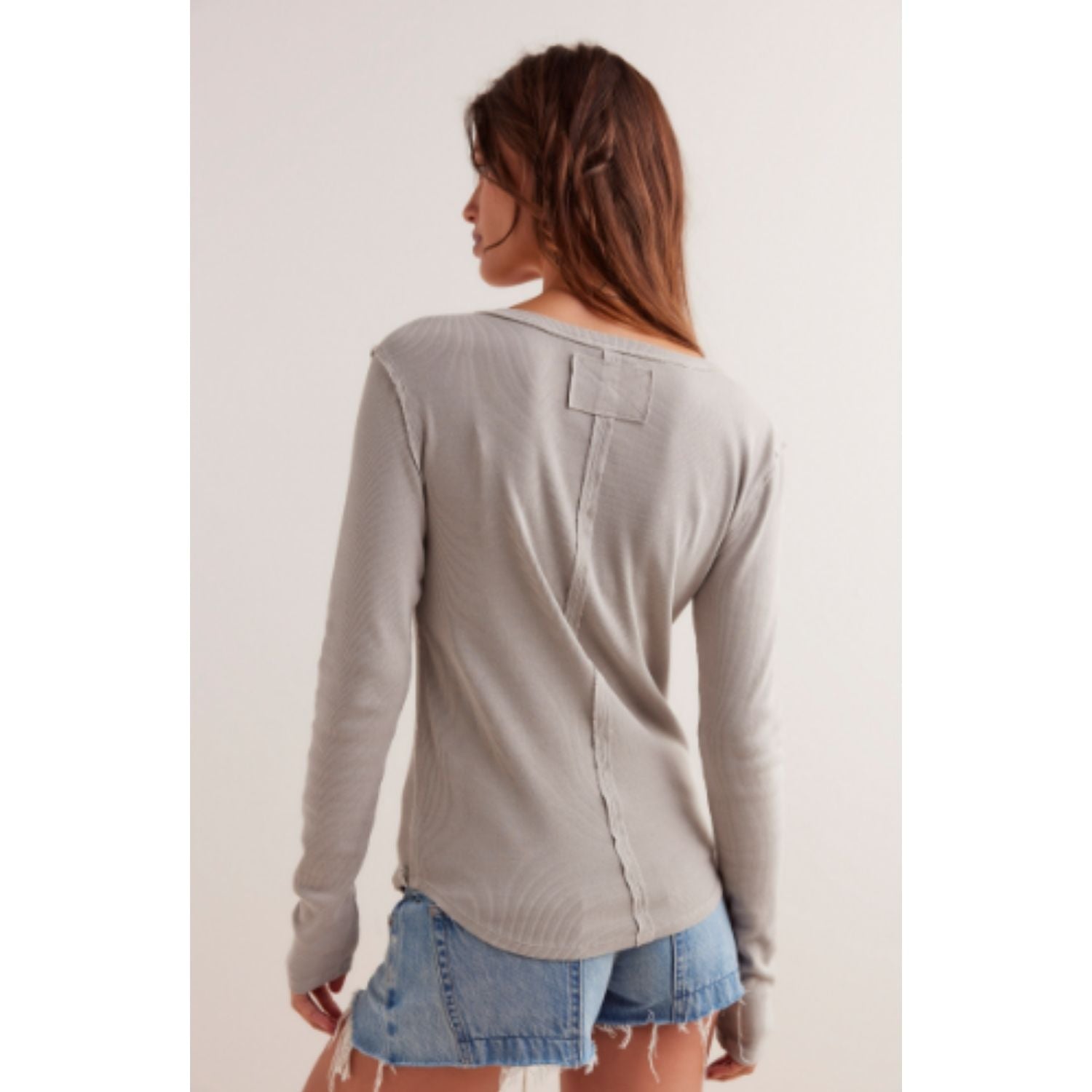 Free People Jamie Henley long-sleeve knit top featuring a slim fit, defined seams, and button-front detailing