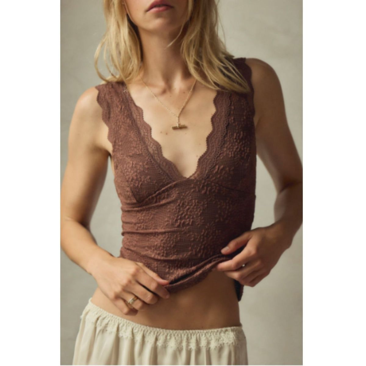 Women's lace tank top featuring a V-neckline, scalloped trim, and feminine open-back detailing