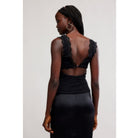 Women's lace tank top featuring a V-neckline, scalloped trim, and feminine open-back detailing