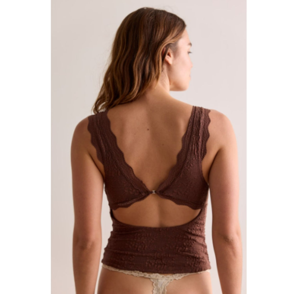 Women's lace tank top featuring a V-neckline, scalloped trim, and feminine open-back detailing