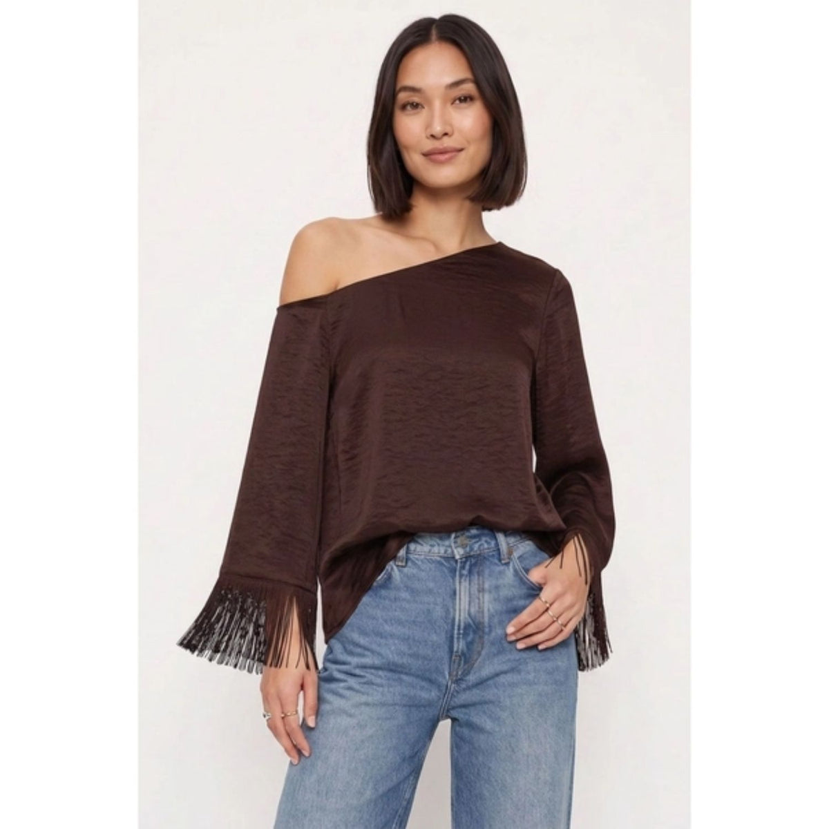 Off-shoulder satin blouse with an asymmetrical neckline and fringe-trimmed sleeves