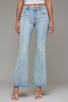 Light wash high-rise flare jeans featuring front seam detailing, a cropped raw hem, and a flattering fitted silhouette through the hips and thighs.