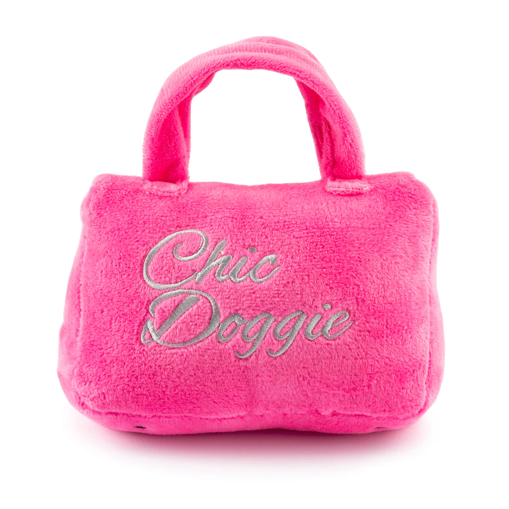 Barkin Bag Plush Dog Toy Pink. For the pup that will only be seen sporting the finest plush purses in their teeth, we present to you: the Pink Barkin Bag, equipped with a fun squeaker inside and festooned with a playful plush scarf. And if there was ever any question about who’s the classiest canine around, the ‘Chic Doggie’ embroidered on the bag sets matters straight!