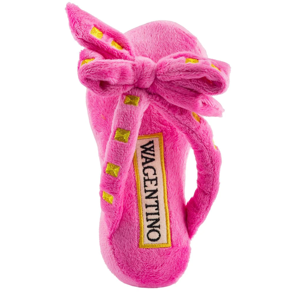 Wagentino Sandal Plush Dog Toy Pink. Don’t let your fashion hound be seen without this signature Wagentino Sandal in their jaws! Made with a lavish-yet-playful plush exterior and featuring a bewitching squeaker inside, this stylish sandal toy is designed to be irresistible inside and out.