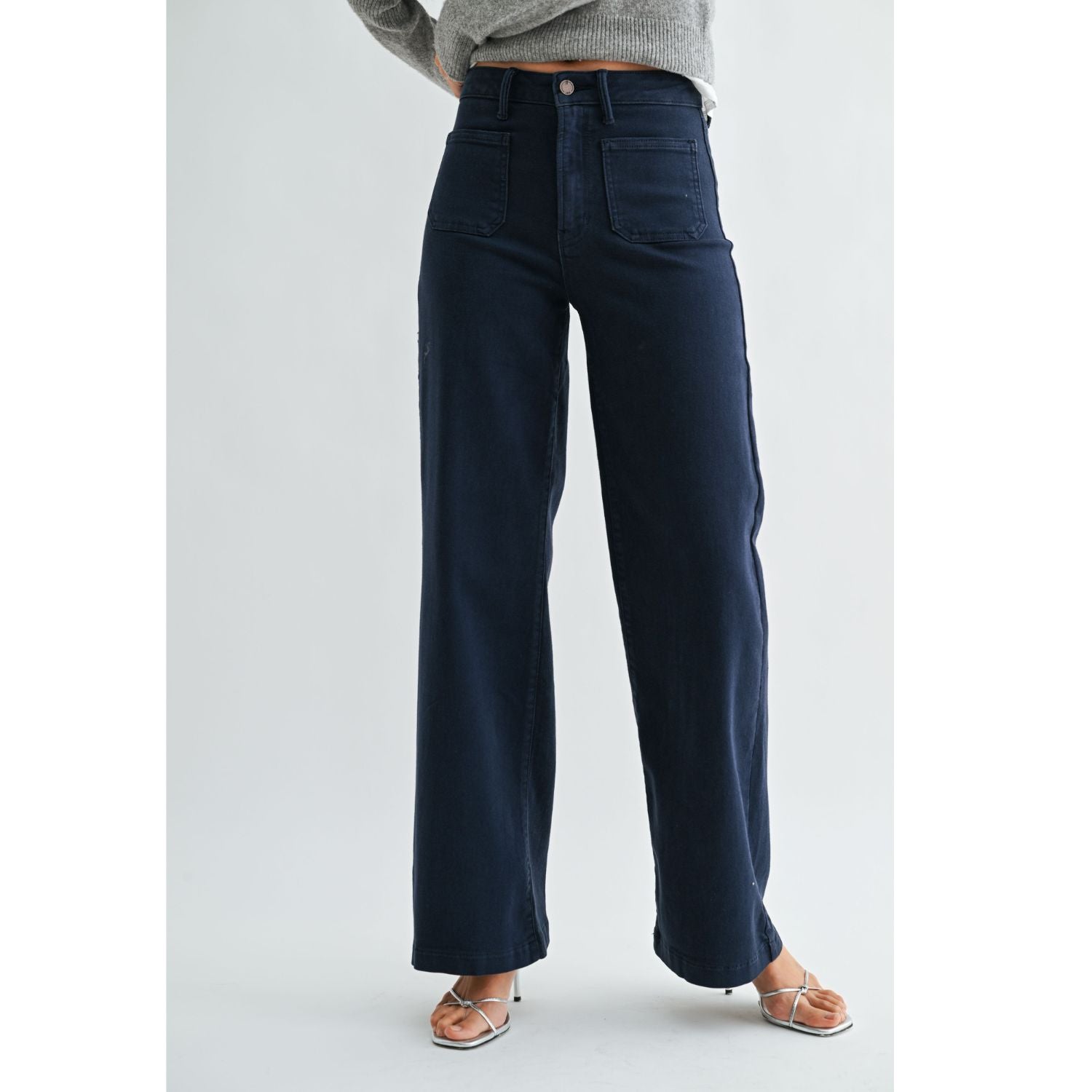 High-rise wide-leg jeans with statement front patch pockets and a relaxed denim silhouette.