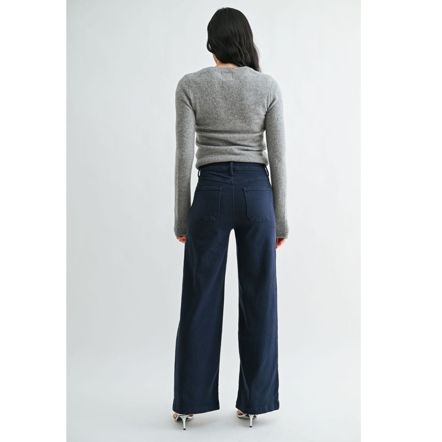 High-rise wide-leg jeans with statement front patch pockets and a relaxed denim silhouette.