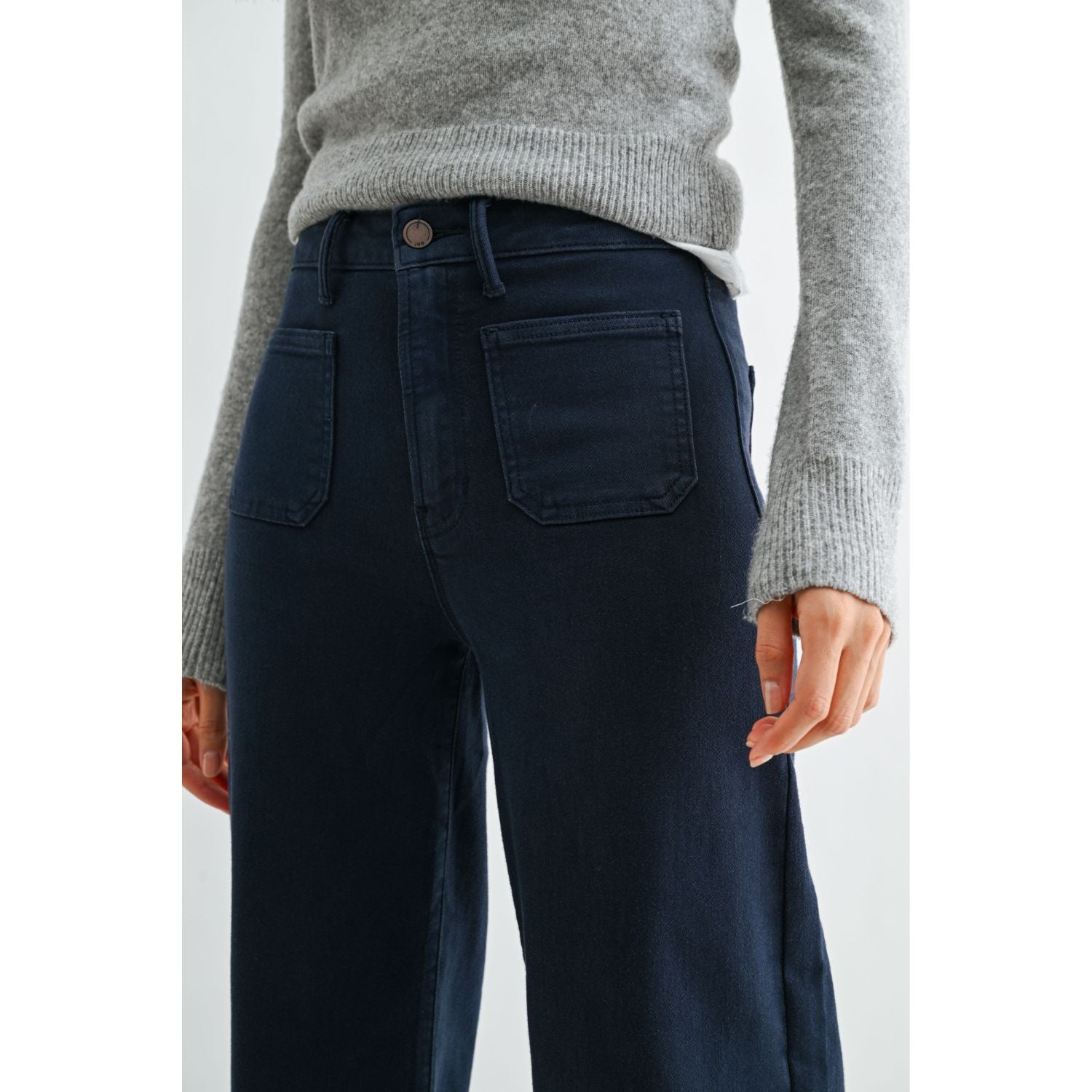 High-rise wide-leg jeans with statement front patch pockets and a relaxed denim silhouette.