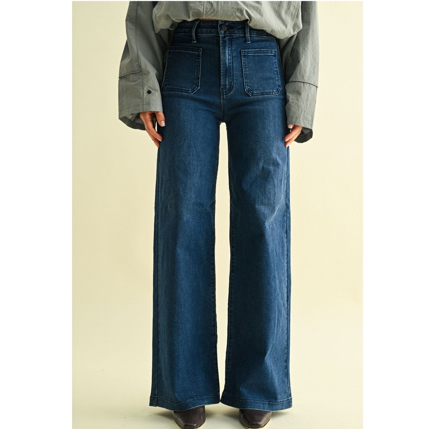 High-rise wide-leg jeans with statement front patch pockets and a relaxed denim silhouette.