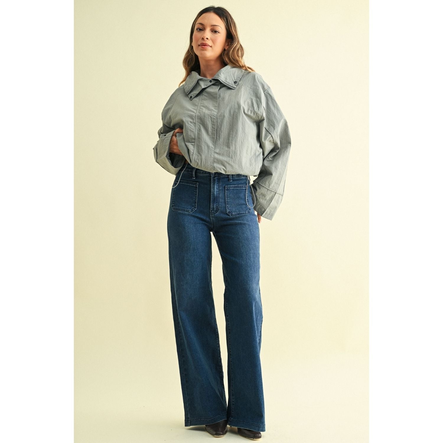 High-rise wide-leg jeans with statement front patch pockets and a relaxed denim silhouette.
