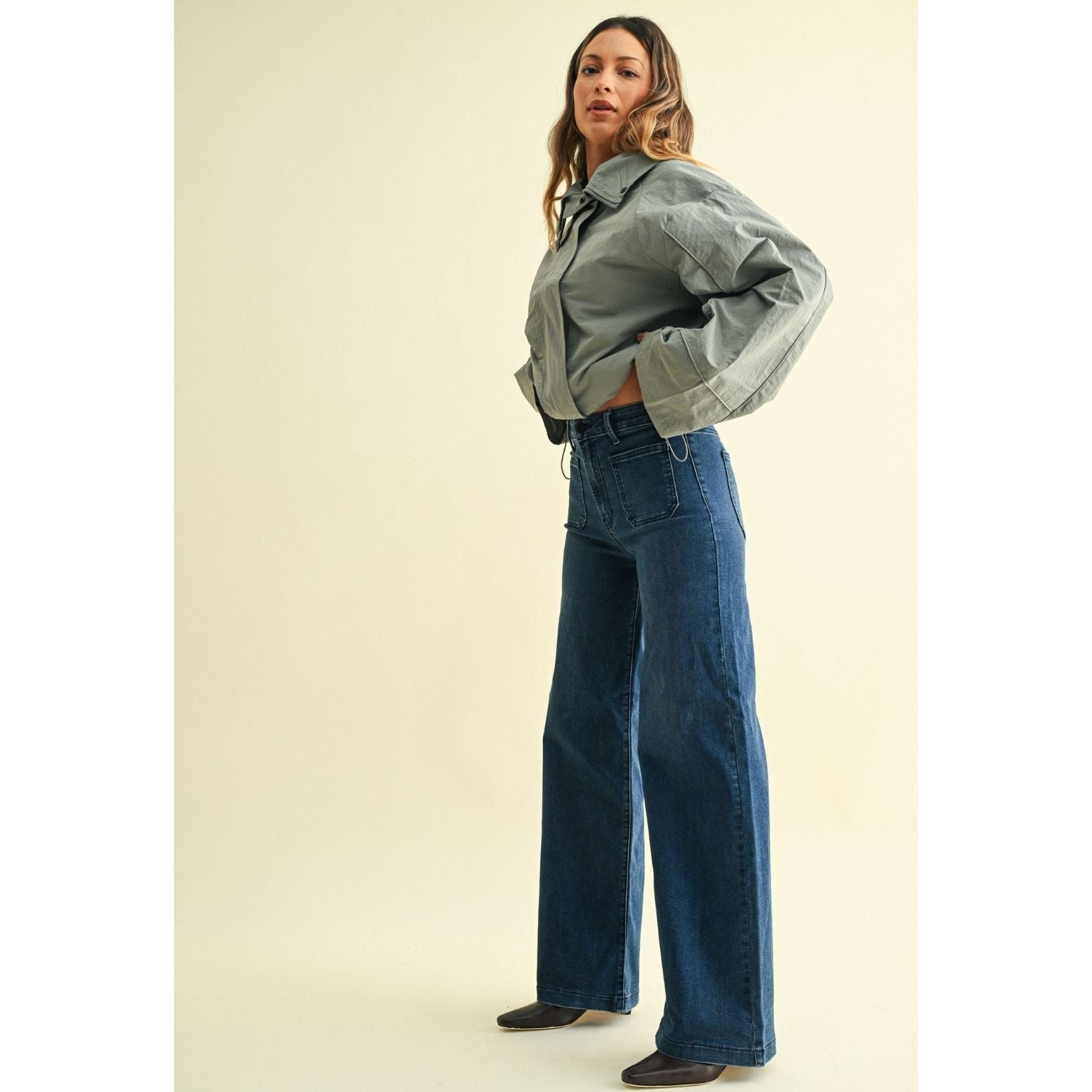High-rise wide-leg jeans with statement front patch pockets and a relaxed denim silhouette.