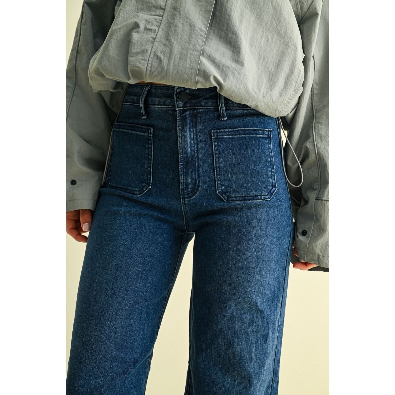 High-rise wide-leg jeans with statement front patch pockets and a relaxed denim silhouette.