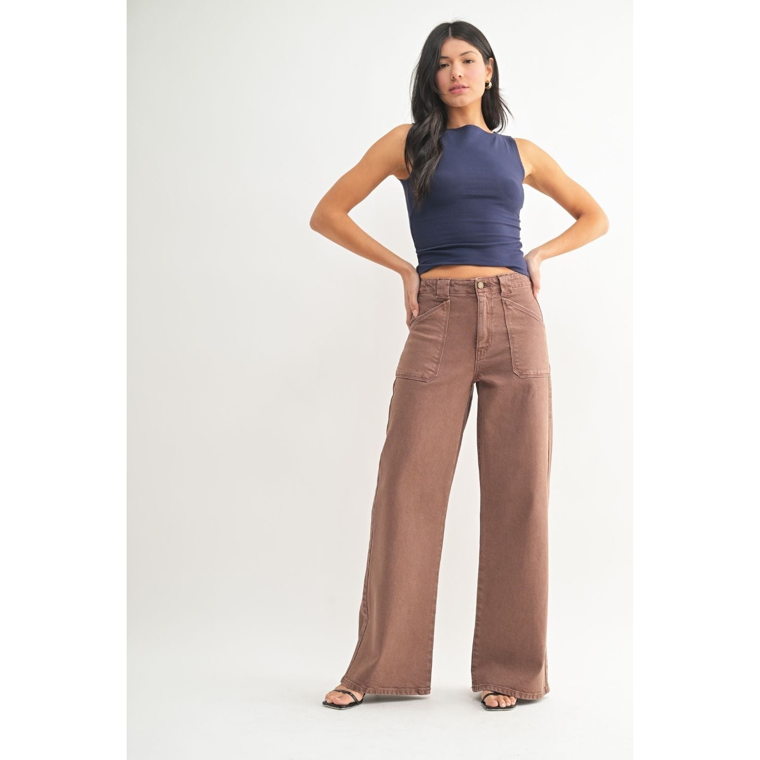 White high-rise wide-leg jeans with front patch pockets, welt back pockets, and silver hardware.