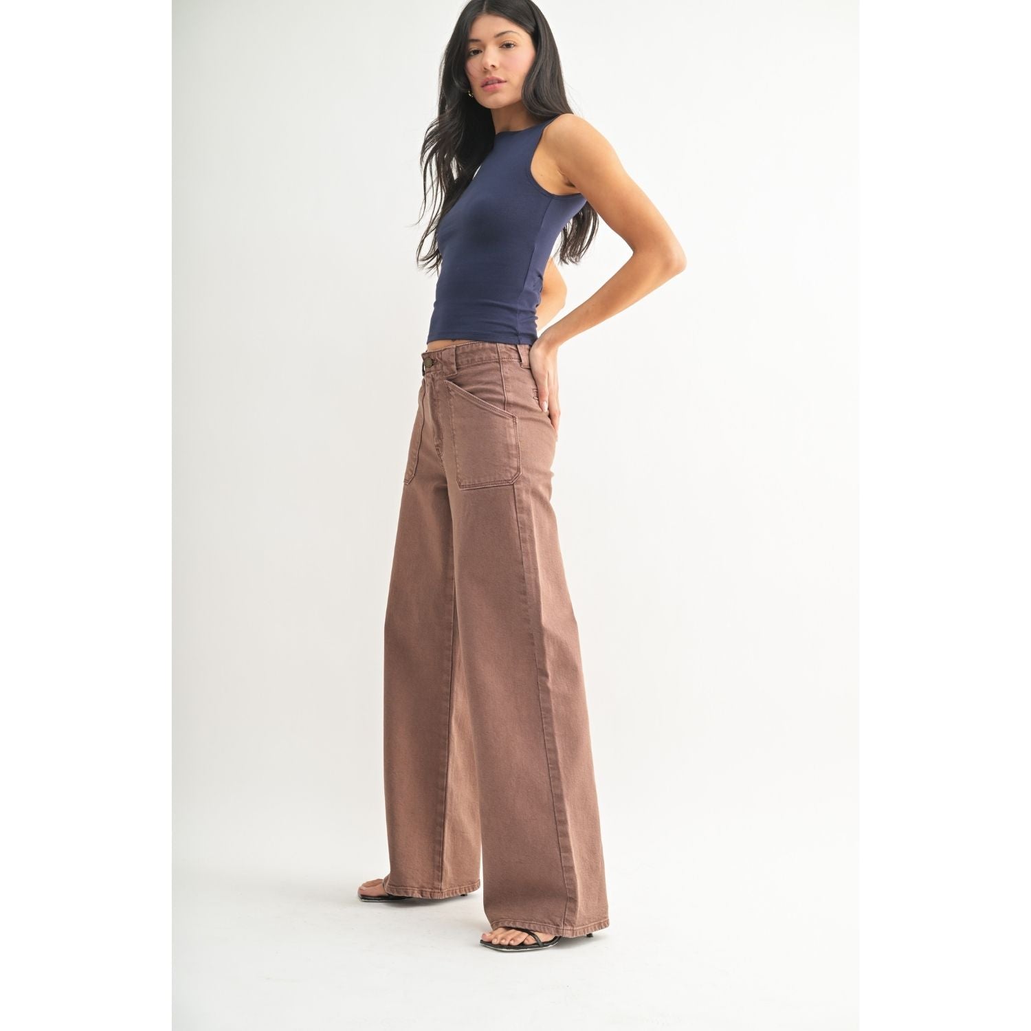 White high-rise wide-leg jeans with front patch pockets, welt back pockets, and silver hardware.