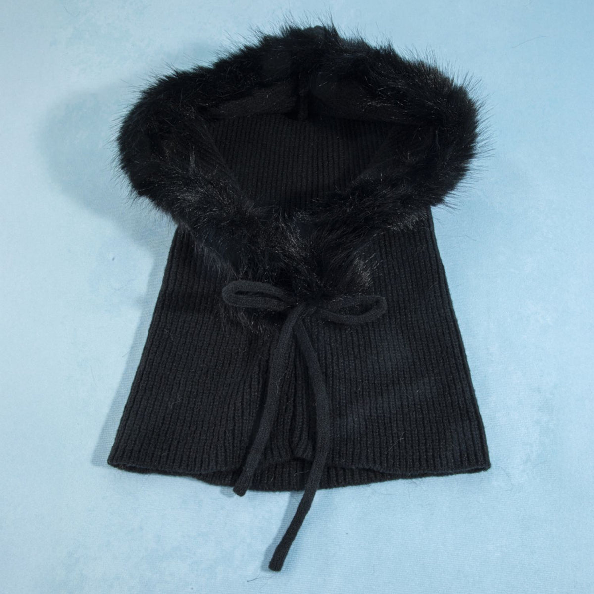 Knit balaclava with plush long-pile trim, ribbed shoulder cape, and tie neckline.